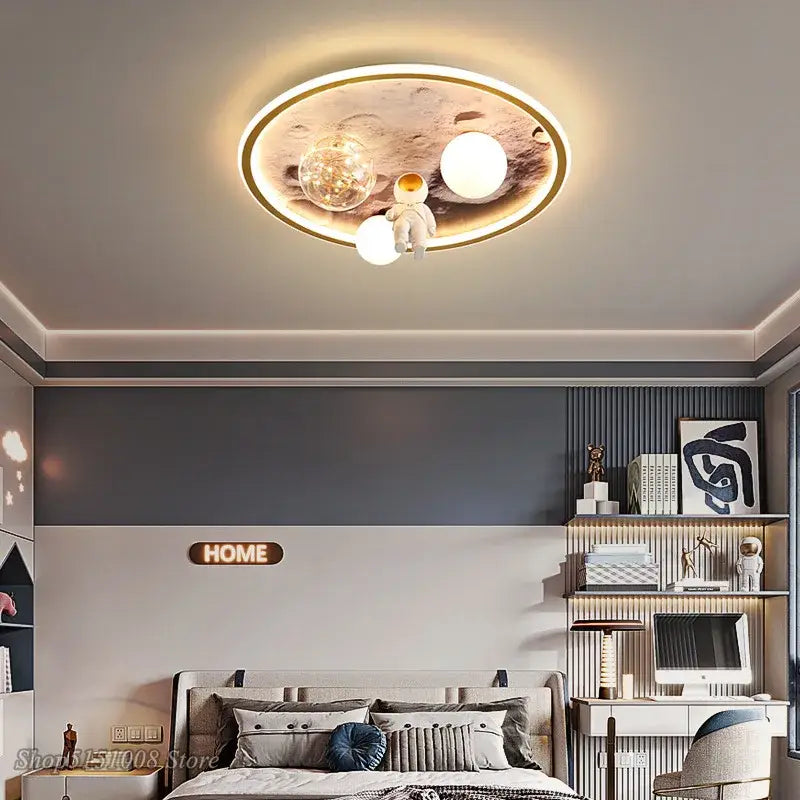 Circular decorbites astronaut led ceiling light with gold frame, astronaut figurine, and three white and clear bulbs for kids room