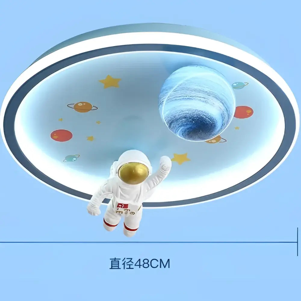 A white astronaut figurine with a gold helmet hangs beneath decorbites astronaut led ceiling lights with planets and stars