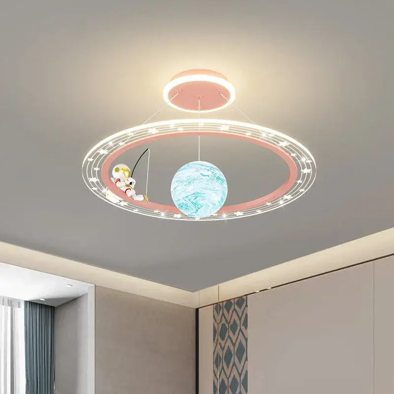 Decorbites astronaut led chandelier with pink glowing ring and blue planet globe featuring a cartoon astronaut fishing