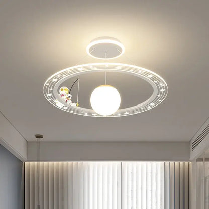 Modern white circular astronaut led chandelier with central orb and figurine fishing on ring for child’s room by decorbites