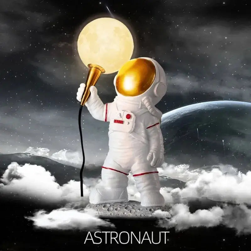 White resin DecorBites astronaut LED desk lamp with gold helmet and moon-shaped lamp for modern desk decor