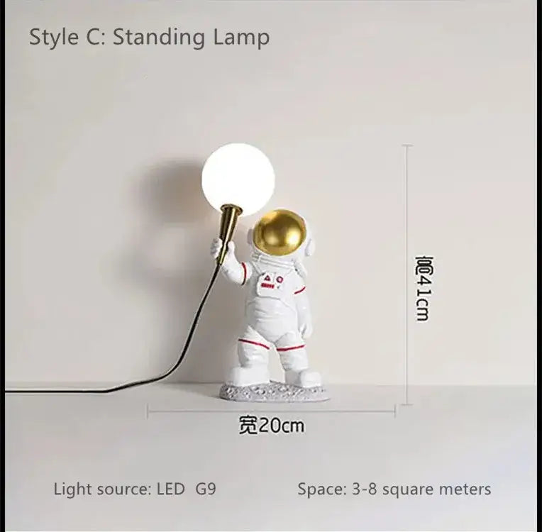 DecorBites™ astronaut led table lamp in white resin with gold helmet and red trim holding spherical led light