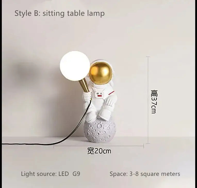 Decorbites™ astronaut led table lamp in white resin with gold helmet and spherical led light on textured gray moon base
