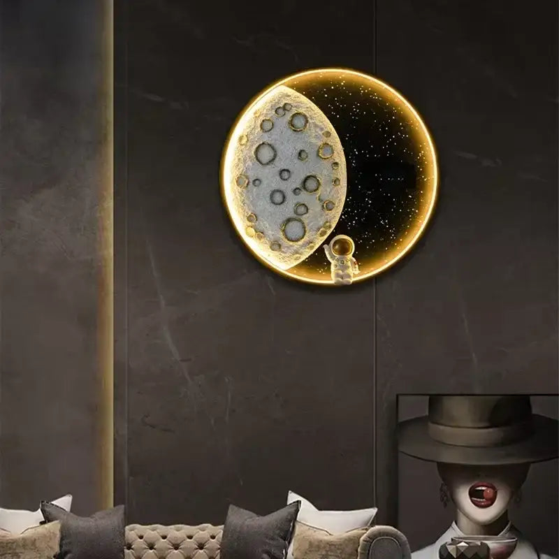 Decorbites™ astronaut led wall lamp with golden moon surface and astronaut figurine on starry black background