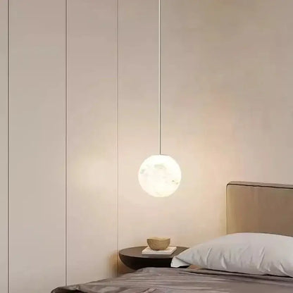Minimalist spherical pendant light with frosted glass globe and metallic cord in DecorBites Astronaut Lunar pendant design