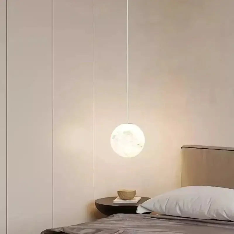Minimalist spherical pendant light with frosted glass globe and metallic cord in DecorBites Astronaut Lunar pendant design