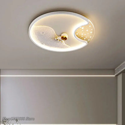 White oval ceiling lamp with moon and star design featuring a central astronaut figurine in decorbites astronaut moon acrylic style