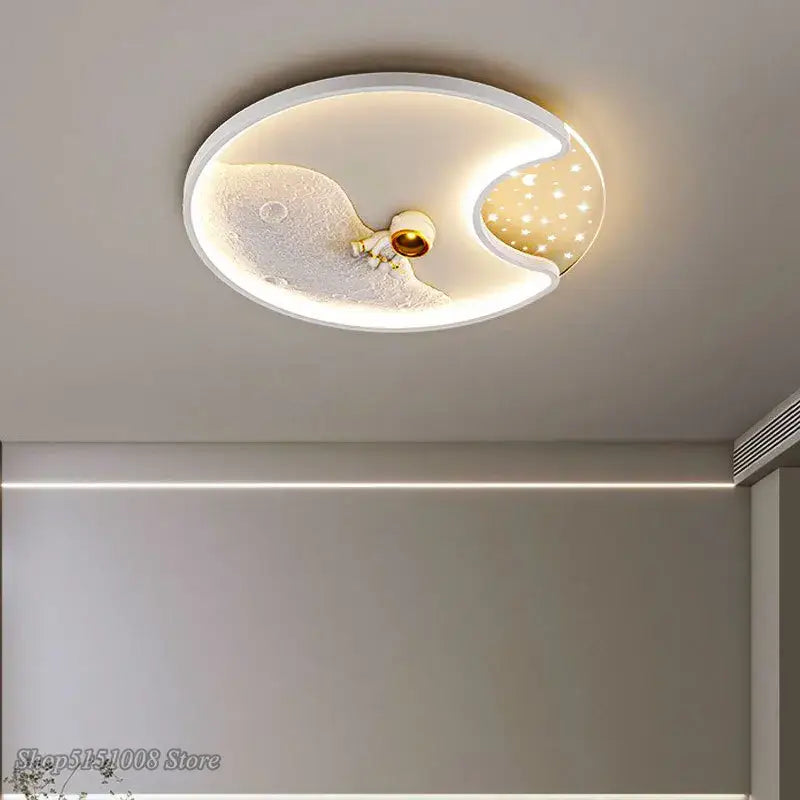 White oval ceiling lamp with moon and star design featuring a central astronaut figurine in decorbites astronaut moon acrylic style