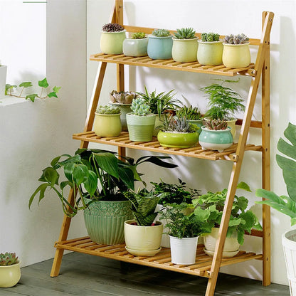DecorBites™ bamboo 3 tier light brown shelf stand with four slatted shelves holding potted plants in colorful pots