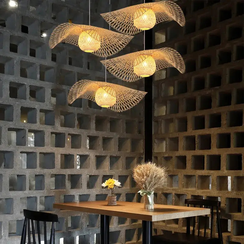 Four hanging woven bamboo lanterns with warm glowing lights in a decorbites bamboo chandelier kitchen pendant light