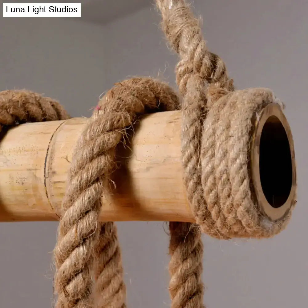 Thick natural-colored hemp rope tightly knotted around light-brown bamboo pole in DecorBites industrial style linear island chandelier beige