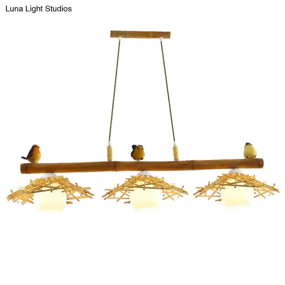 Natural bamboo pendant lighting with three woven nest shades and white glass art deco bird figurines by DecorBites