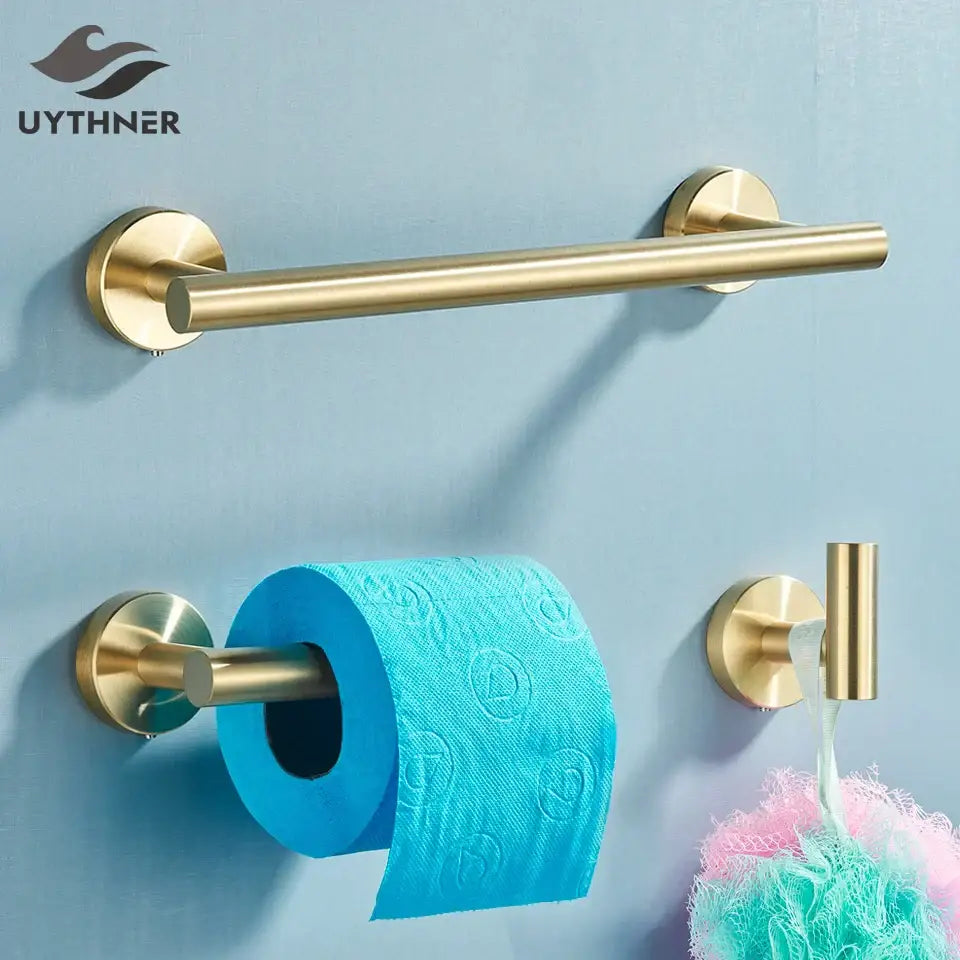 Brass-finished bathroom towel rack with sleek cylindrical design and wall-mounted circular brackets in DecorBites bathroom hardware set