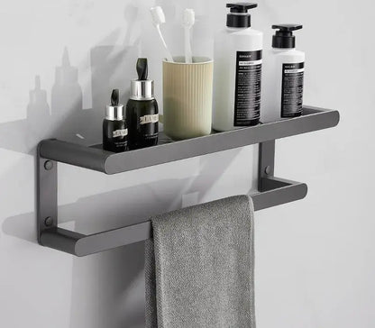 Modern matte black metal bathroom shelf with integrated towel bar holding toiletries in decorbites bathroom hardware set