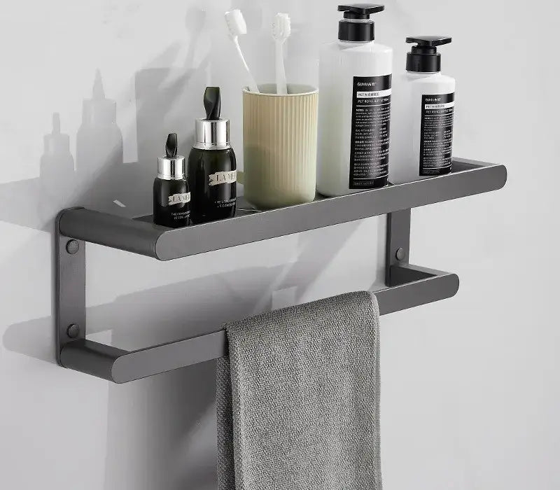 Modern matte black metal bathroom shelf with integrated towel bar holding toiletries in decorbites bathroom hardware set
