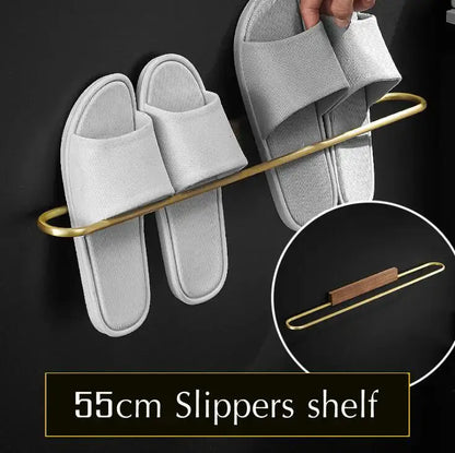 Gold-toned metal slipper shelf with curved design and wooden accent from DecorBites bathroom hardware set in space aluminum