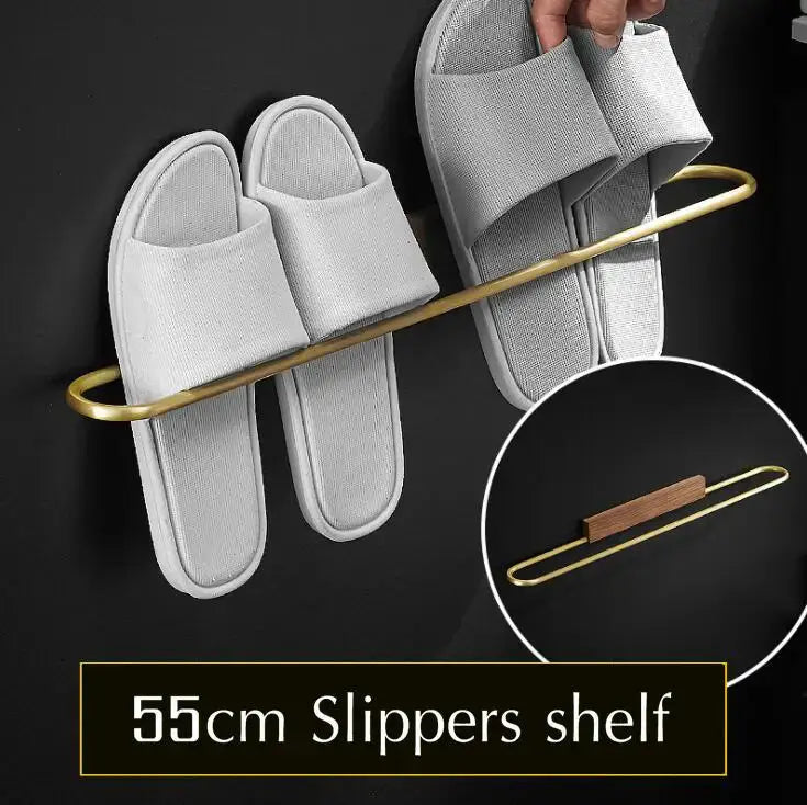 Gold-toned metal slipper shelf with curved design and wooden accent from DecorBites bathroom hardware set in space aluminum