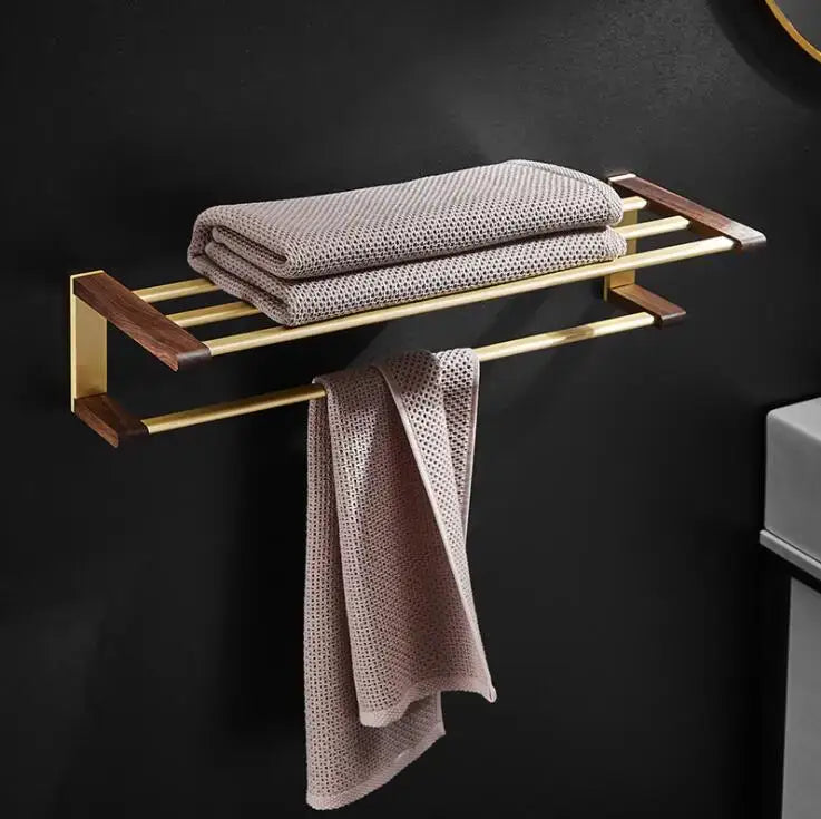Gold-toned towel rack with dark wood accents and woven texture from decorbites™ bathroom hardware set in space aluminum
