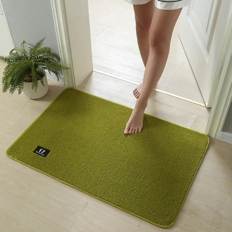 A soft olive green decorbites bathroom mat with a plush textured surface and rounded edges for non slip use