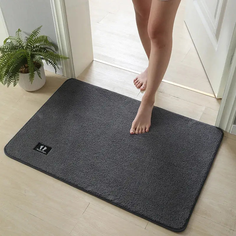 Dark gray plush decorbites bathroom mat with subtle black logo patch features super non-slip and quick drying rug