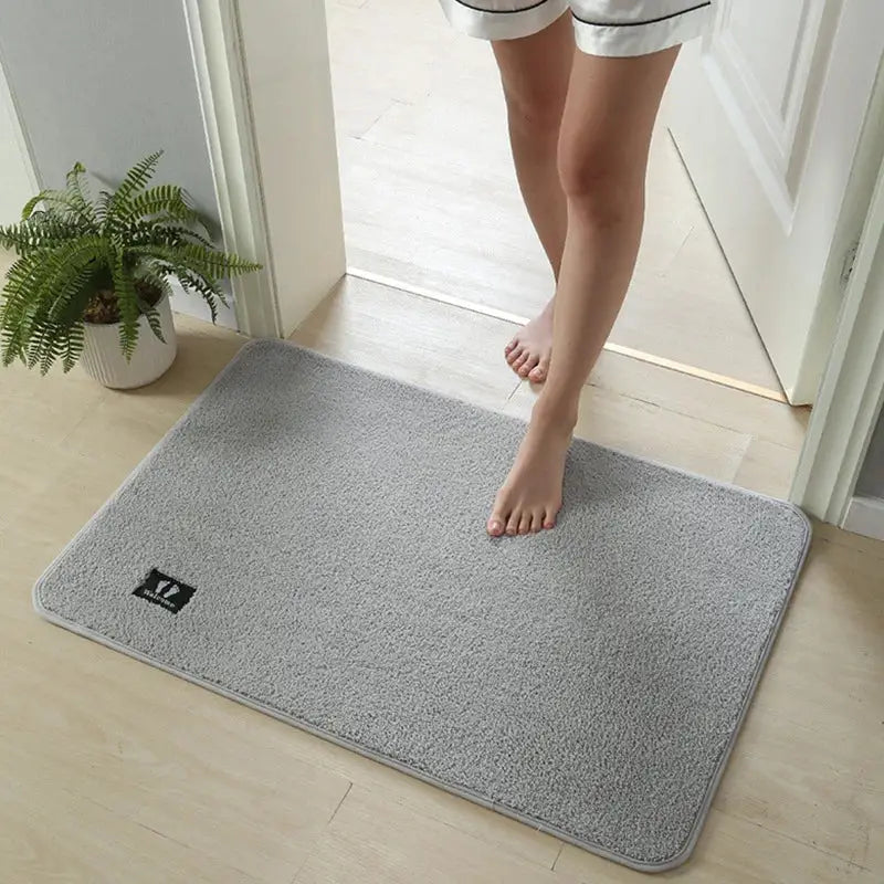 Gray plush rectangular decorbites bathroom mat with subtle texture and non slip absorbent quick drying surface