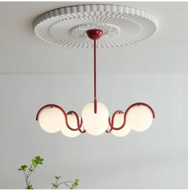 Red metal decorbites bean glass pendant light with three frosted globes and white ceiling rose for living room use