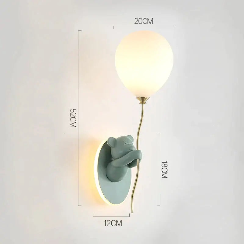 A mint-green ceramic bear artistic kids wall lamp by DecorBites holding a frosted glass balloon with brass stem