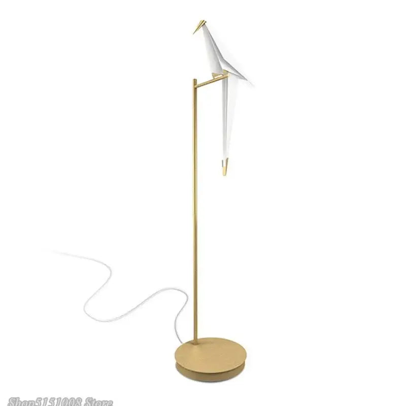 Minimalist decorbites bird origami floor lamp with slender gold metal stand and white origami crane for living room use