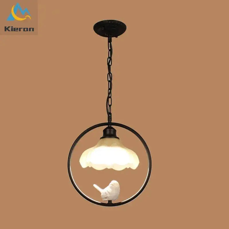 Black metal circular pendant light with frosted glass shade and white bird figurine in decorbites birdcage led chandelier