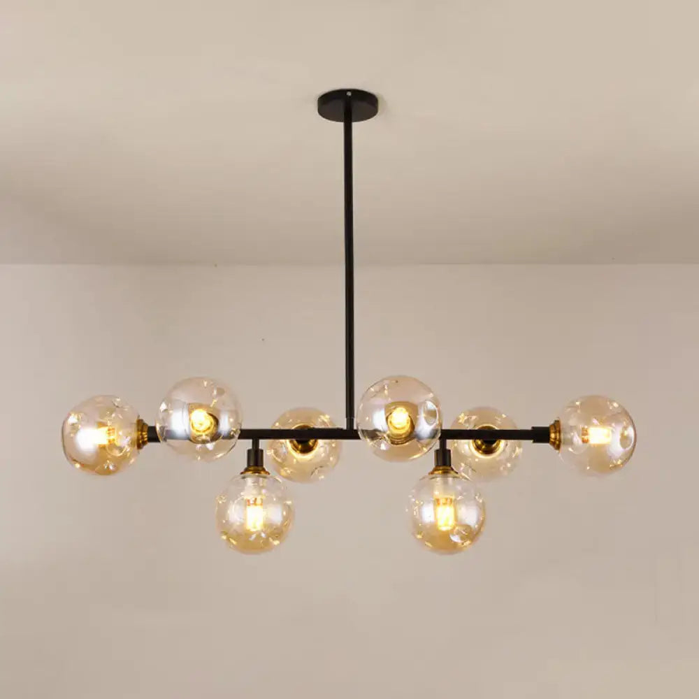 Modern black metal chandelier light type with clear glass globe bulbs and brass accents for dining room island use