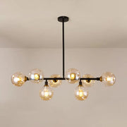 Modern black metal chandelier light type with clear glass globe bulbs and brass accents for dining room island use