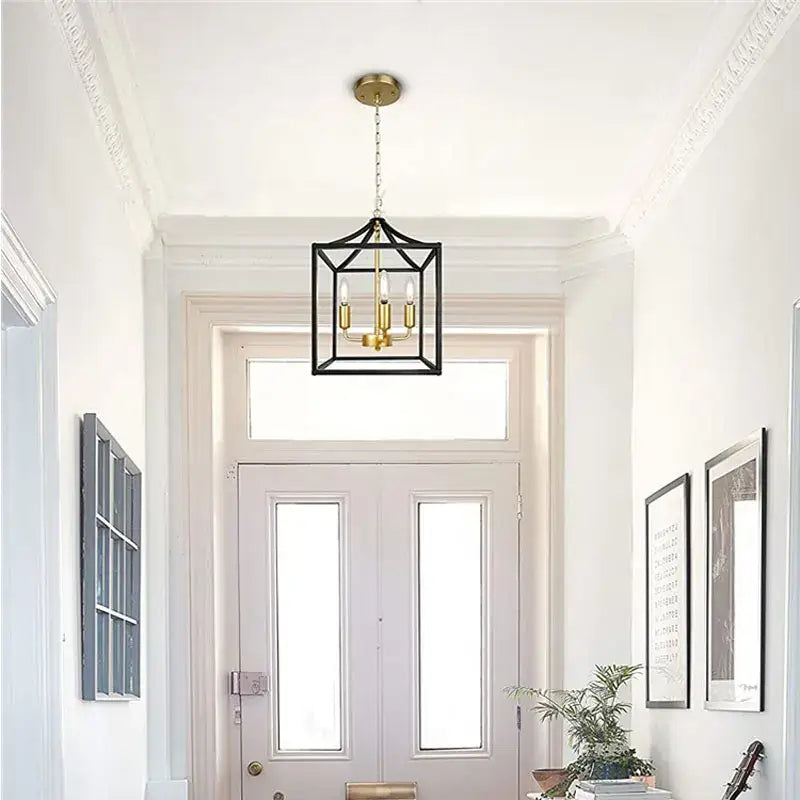 Decorbites black farmhouse chandelier pendant light with black metal lantern style and brass accents featuring four bulbs
