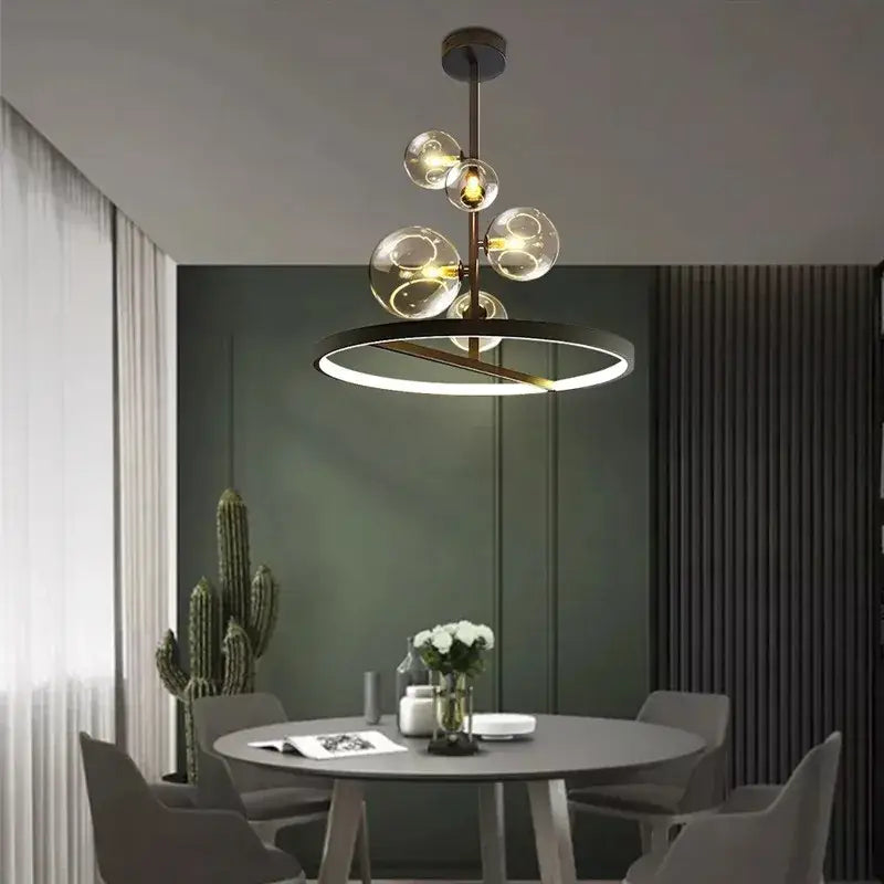 Modern brass-finished led pendant chandelier with clear glass globe bulbs and circular led ring for dining room use