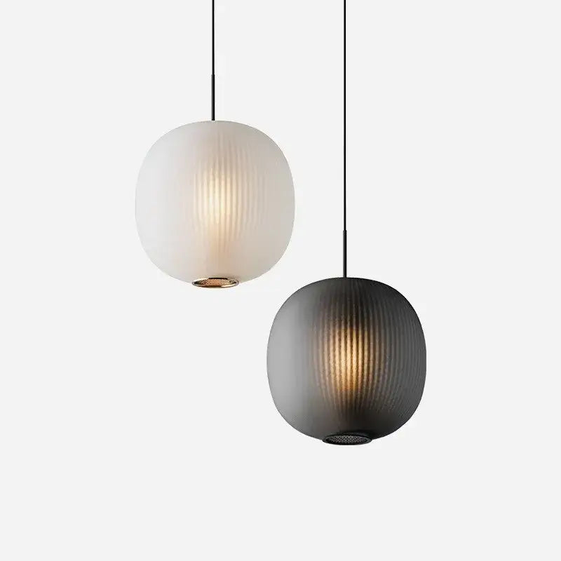 Two spherical pendant table lights with vertical ribbed glass shades in frosted white and matte black decorbites black glass ball