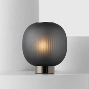 DecorBites black glass ball table light with sleek dark gray frosted glass and brushed metal base for bedroom use