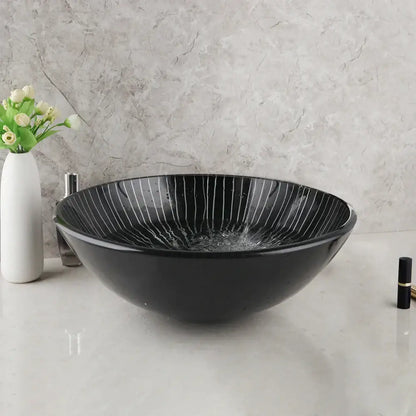 Decorbites black glass bathroom sink set featuring a black glass vessel sink with subtle white radial stripes and waterfall faucet