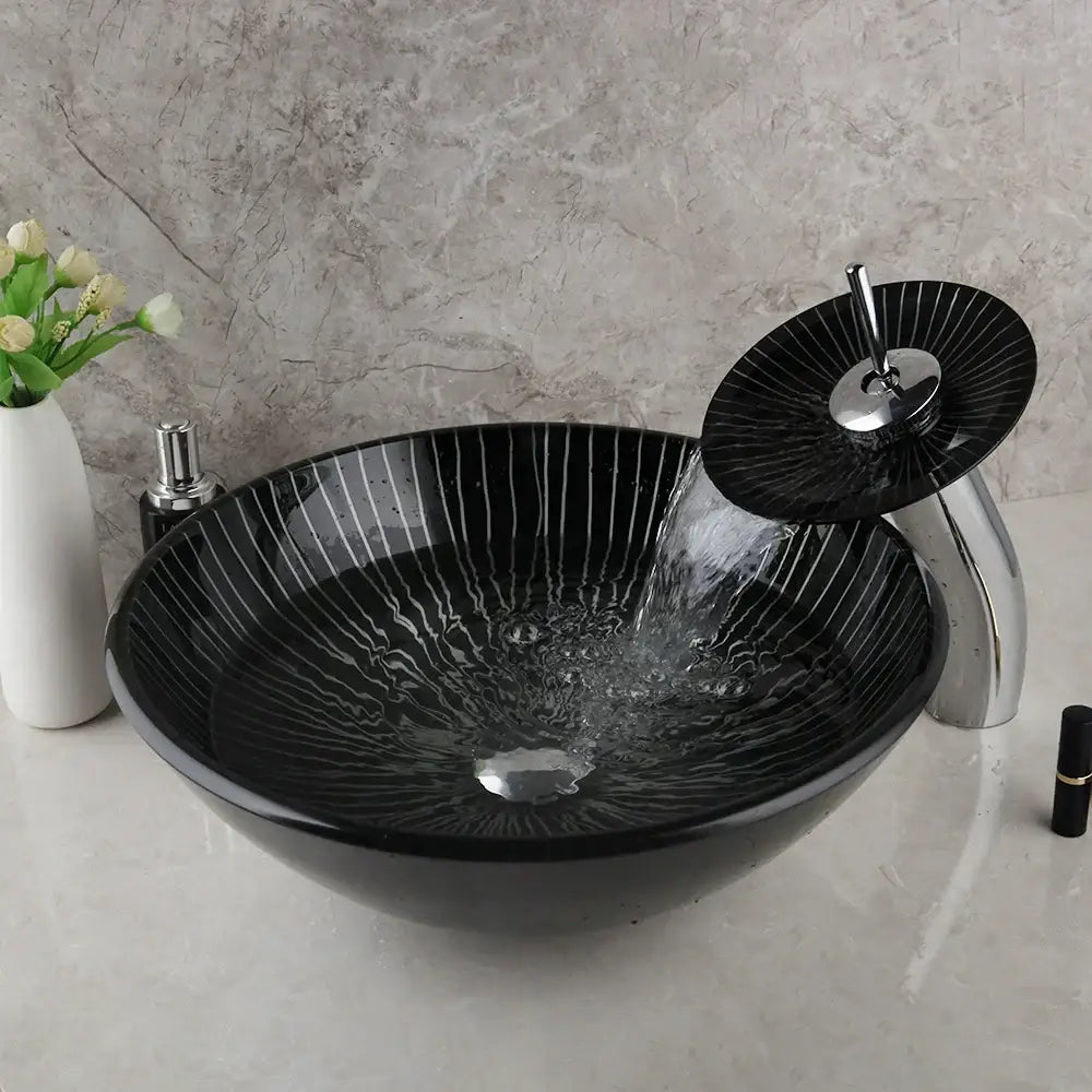 Decorbites black glass sink set featuring a black glass bathroom vessel sink with vertical white stripes and matching waterfall faucet