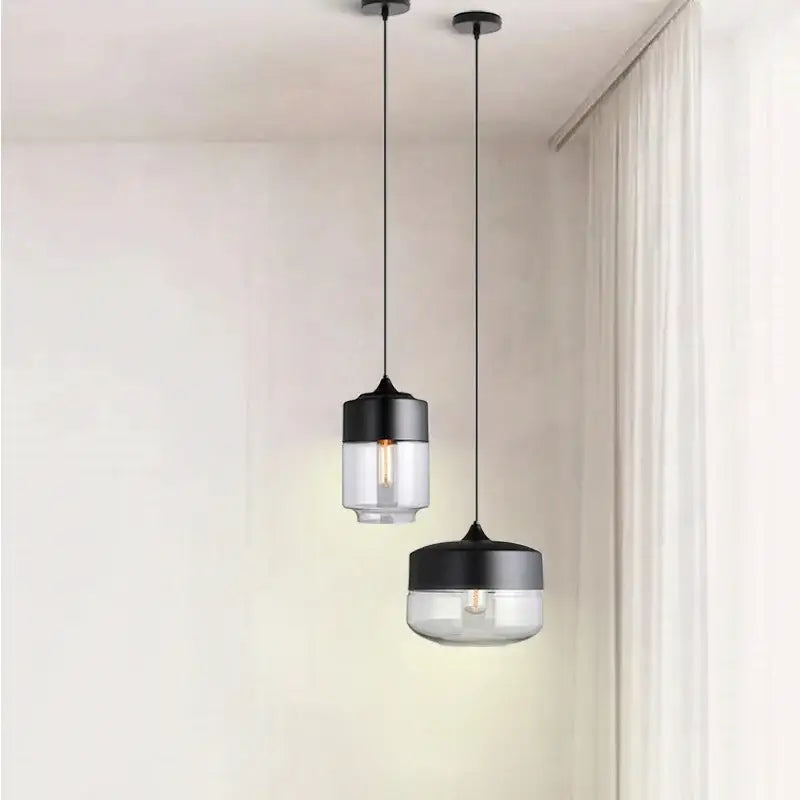 Two black glass pendant lights with clear glass shades from decorbites black glass pendant collection for modern spaces