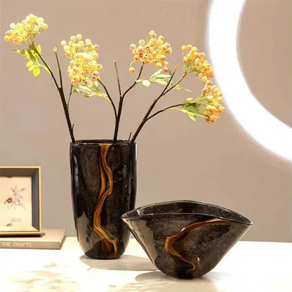 Decorbites black glass vase featuring glossy black ceramic with amber-gold marbled patterns for floral arrangement