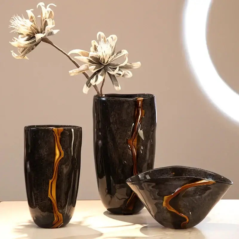 Set of three decorbites black glass vases with glossy black glaze and amber-gold veining for floral arrangement