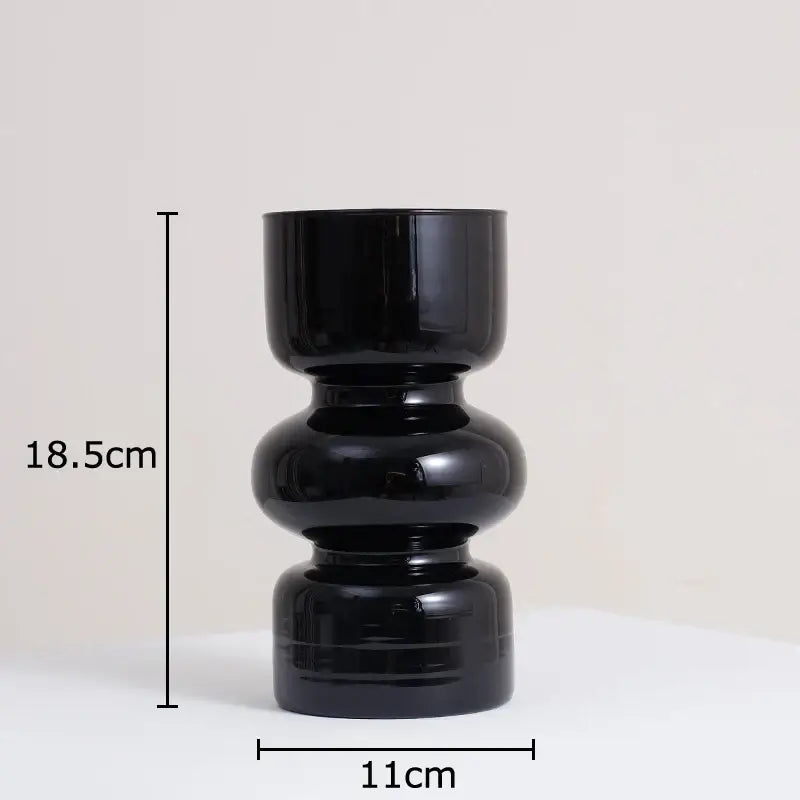 DecorBites black glass vase with stacked rounded segments and artificial flowers for minimalist room decor