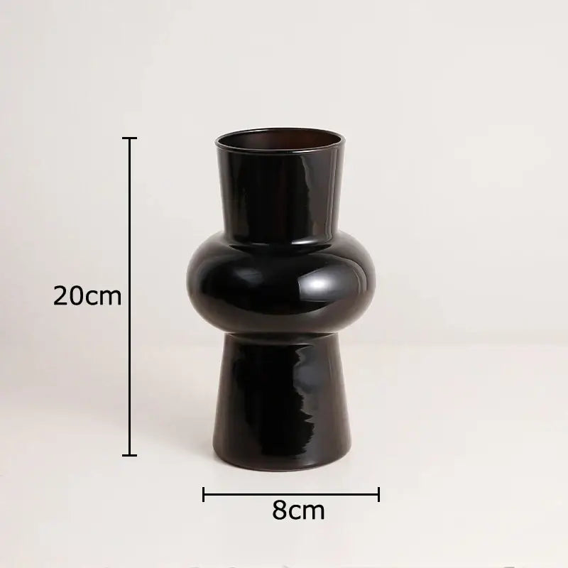 A sleek black glass vase by DecorBites with a glossy ceramic finish and artificial flowers for stylish decor