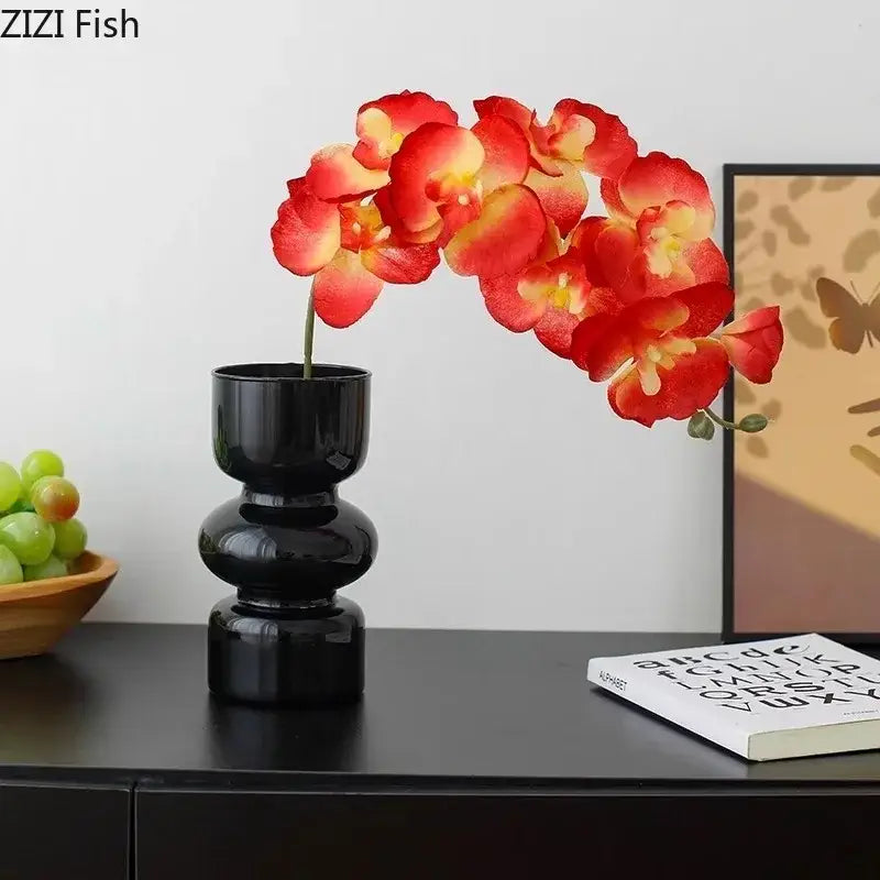 DecorBites black glass vase with glossy black ceramic tiers holding vibrant red and yellow artificial flowers