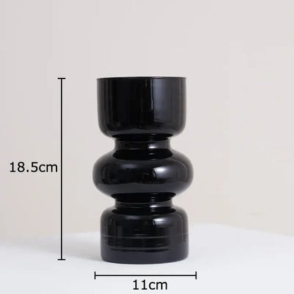 DecorBites black glass vase with stacked rounded segments in black ceramic and artificial flowers for stylish decor