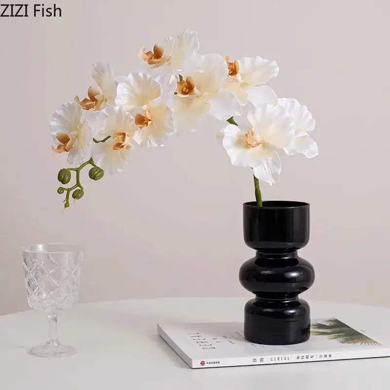 Decorbites black glass vase with stacked segments holding white and peach artificial flowers for stylish room decor