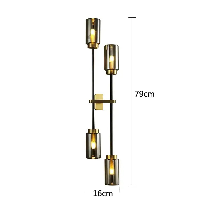 Modern decorbites black glass wall lamp with four cylindrical smoked glass shades and brass accents on black metal arms