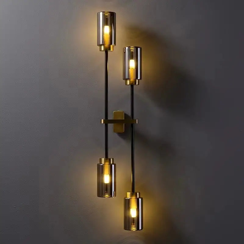Modern brass and smoked glass DecorBites black glass wall lamp with three cylindrical light fixtures for living room decor