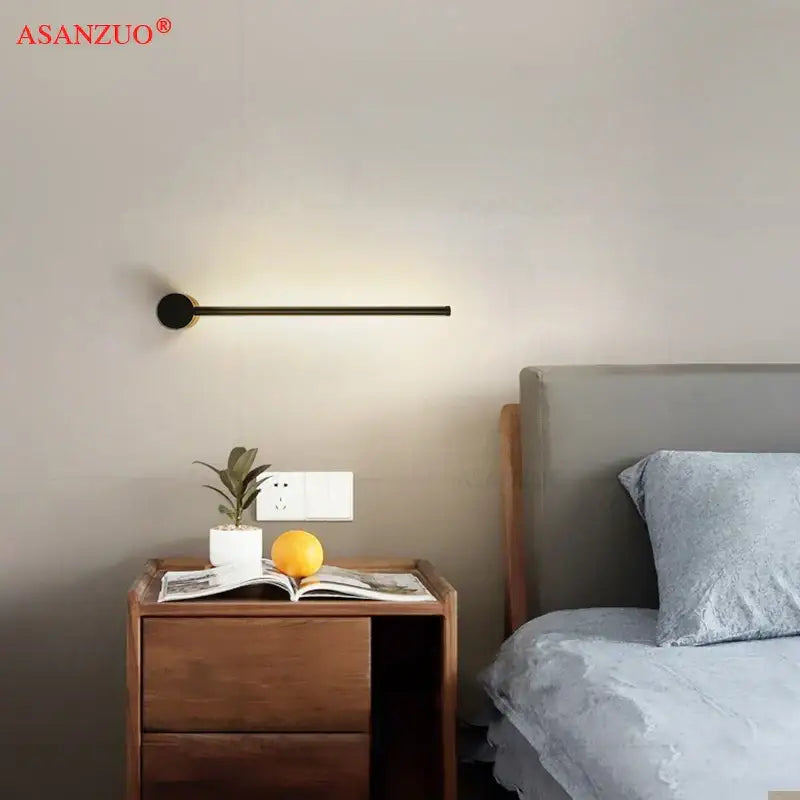 Decorbites black gold aluminum wall sconce with a black minimalist cylindrical base and slender horizontal LED bar for modern decor