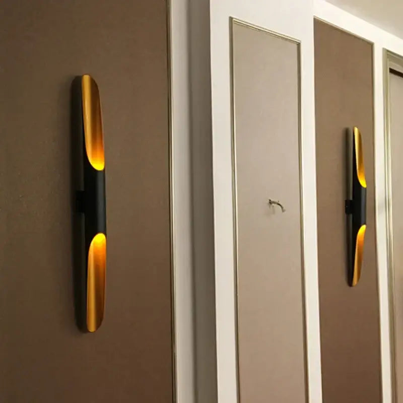 Modern gold and black aluminum tube wall sconce by DecorBites with sleek elongated design for bedroom living room decor