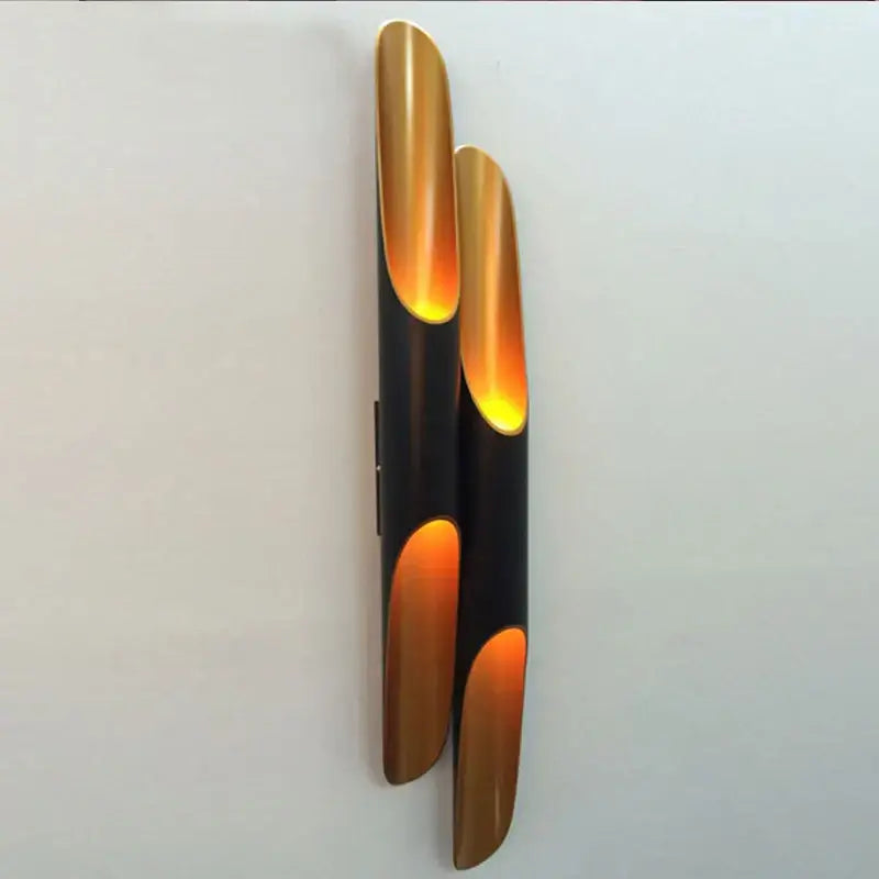 DecorBites black gold tube wall sconce with sleek black and brushed gold finish and three amber-gold light panels